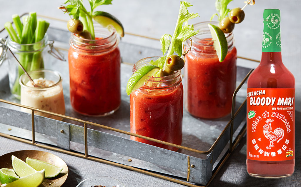 rg_brand_srirachahuyze32_bloodymarymix image of sriracha bloody mary mix and bloody marys in metal tray