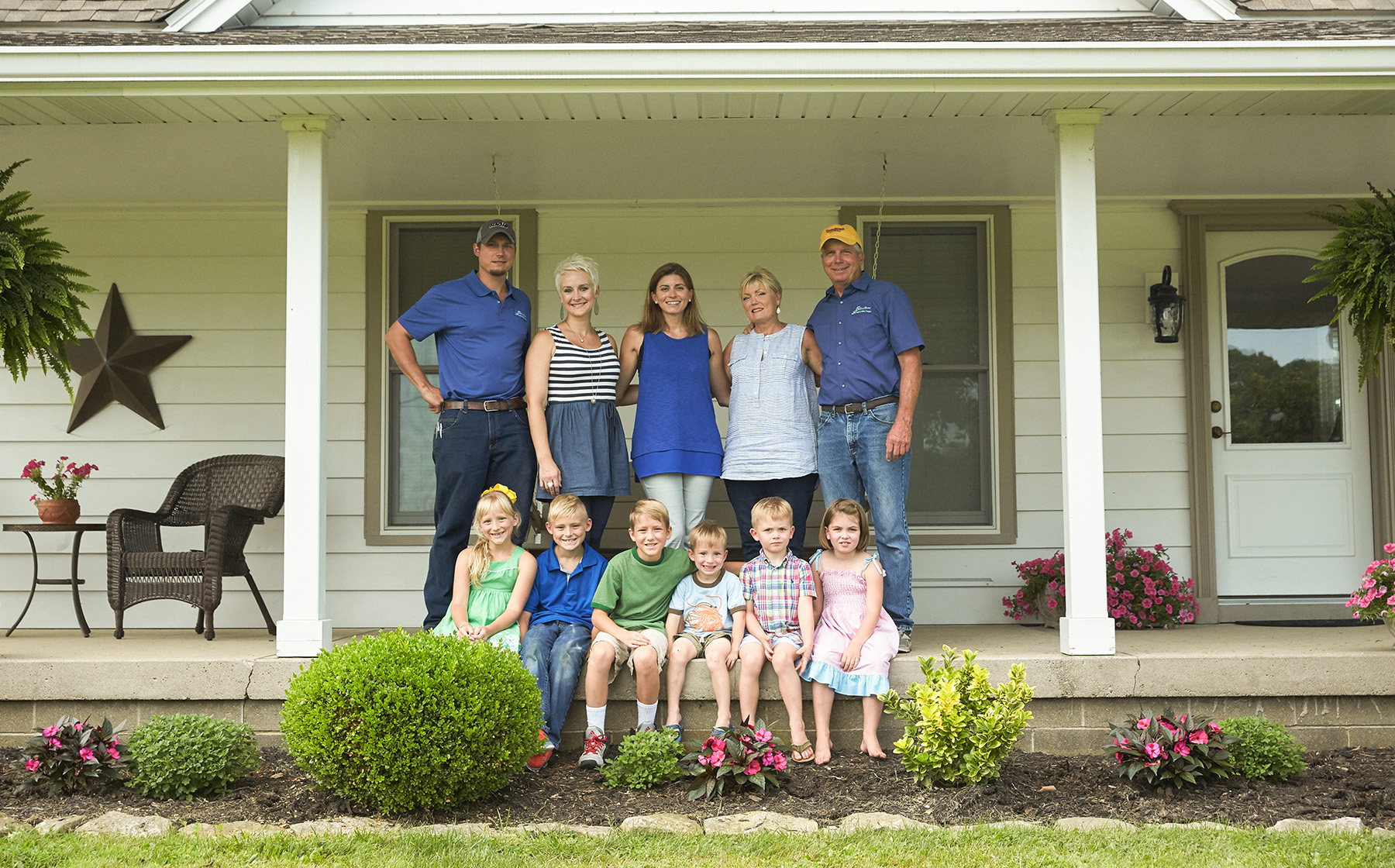 Image of Gelfius Family Farms Growers for Red Gold Tomatoes from Hartsville Indiana standing on front porch