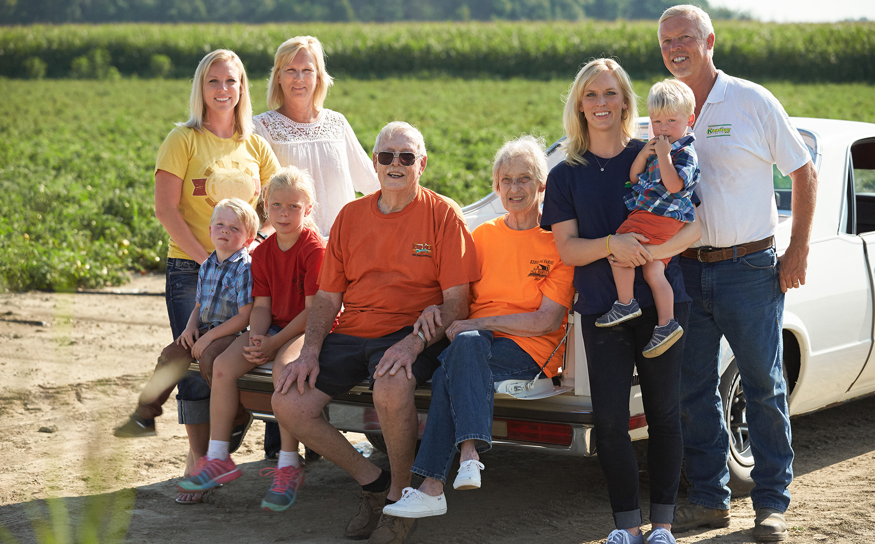 Image of Keesling Farms Growers for Red Gold Tomatoes Keesling family sitting on tailgate of El Camino