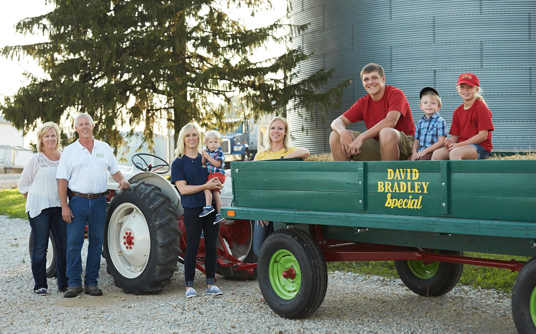 Image of Keesling Farms Growers for Red Gold Tomatoes Keesling family on the farm with tractor and green wagon
