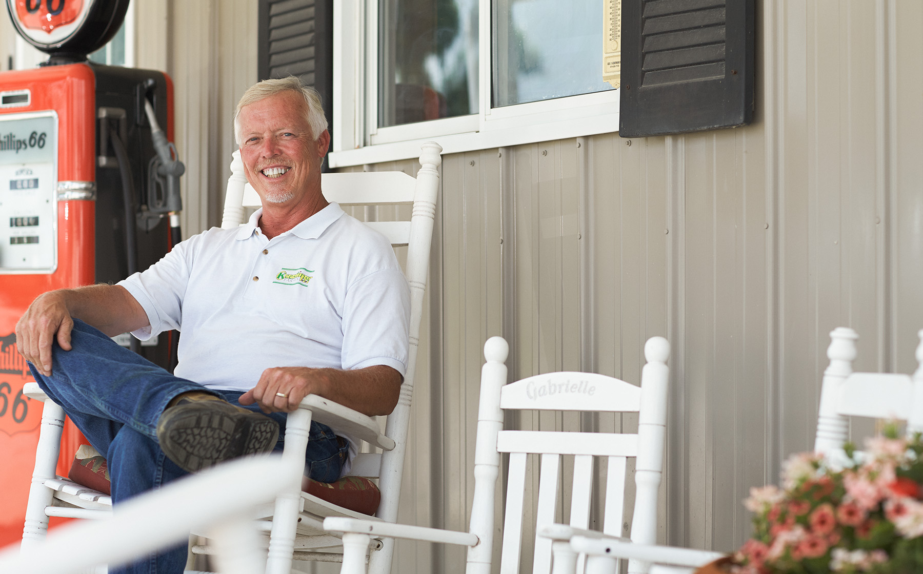 Image of Keesling Farms Growers for Red Gold Tomatoes David Keesling in rocking chair on front porch