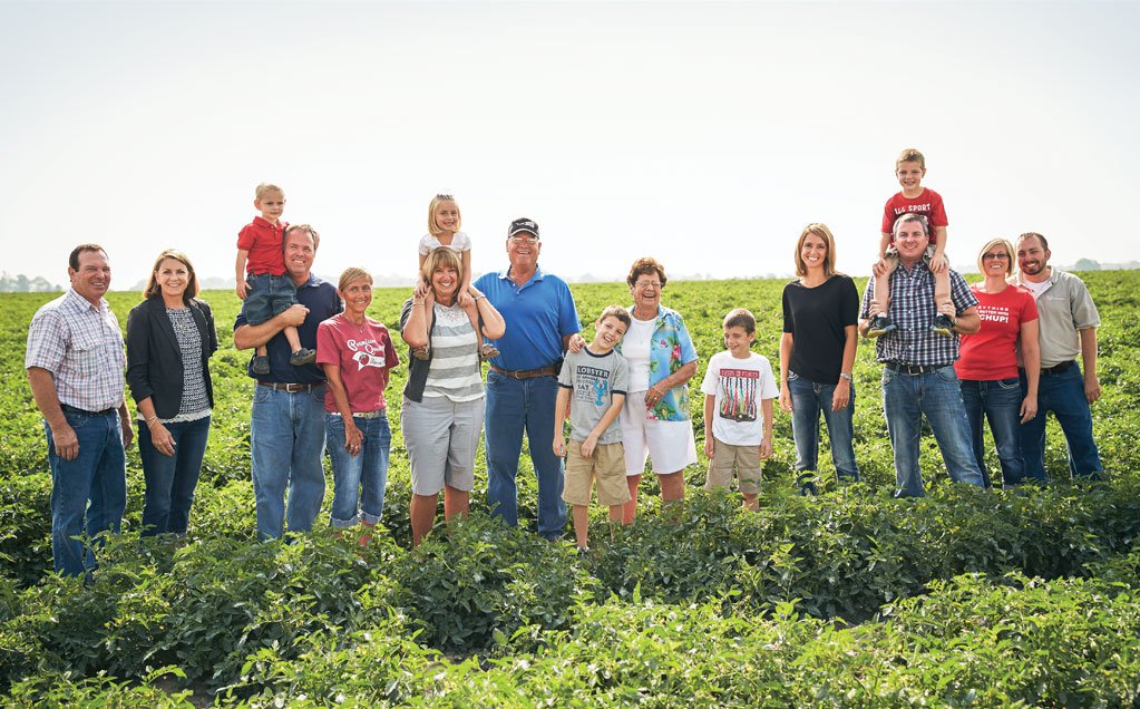 Image of Red Gold tomato growers the Middlesworth Family from Marion Indiana family standing in tomato field