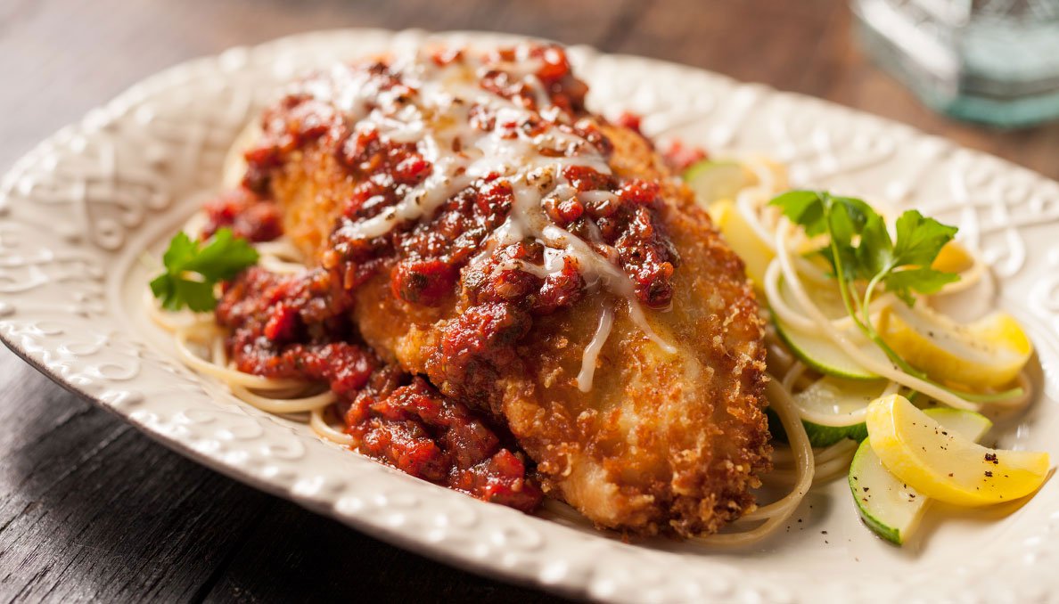 Image of Chicken Parmesan on cream colored decorative plate