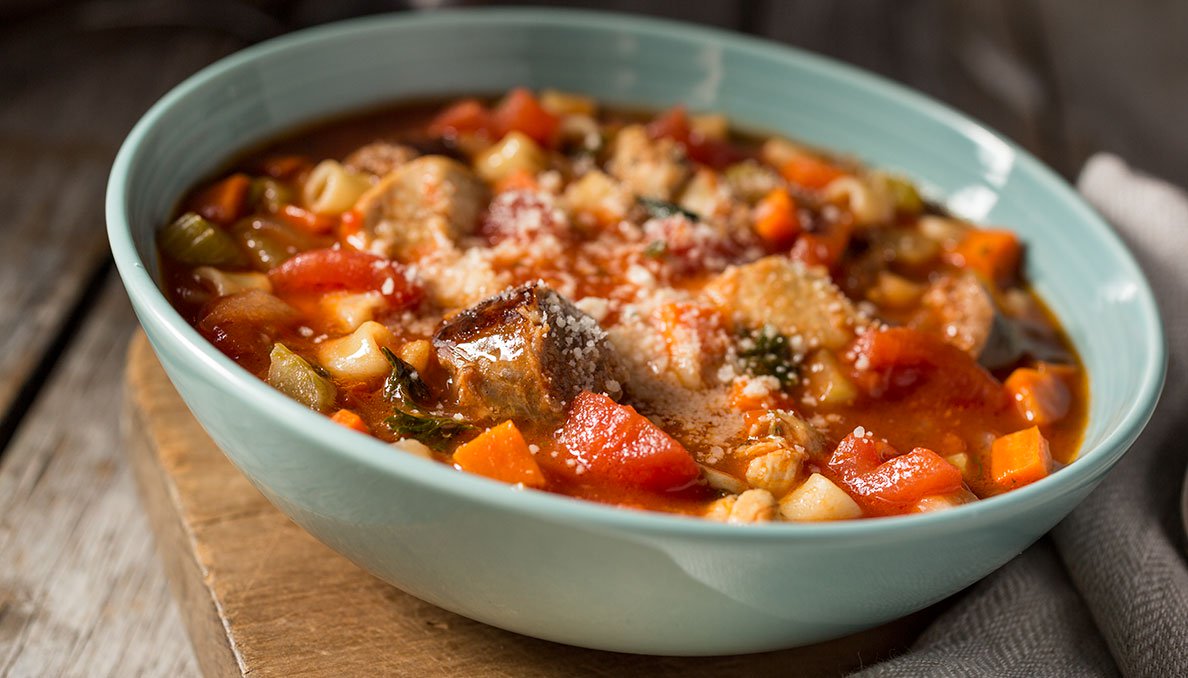Chicken Sausage Stew Image of Chicken Sausage Stew in bowl showing diced tomatoes diced carrots and other vegetables