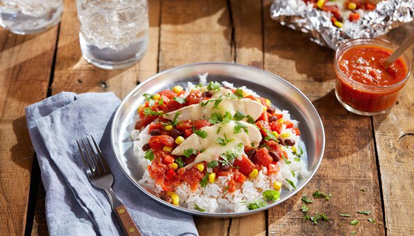 Image of Red Gold Tomatoes Southwest Foil Packet chicken recipe plated with Red Gold Salsa on wodd table