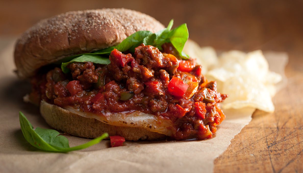 Italian Sloppy Joe Image of Italian Sloppy Joe with basil and chips in background