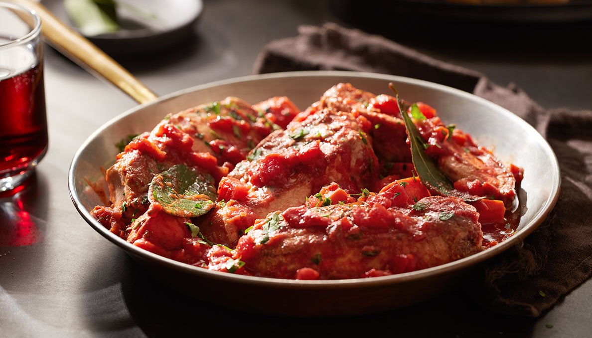 Image of Red Gold Tomatoes recipe Braised Country Style Pork Ribs with diced tomatoes in a skillet