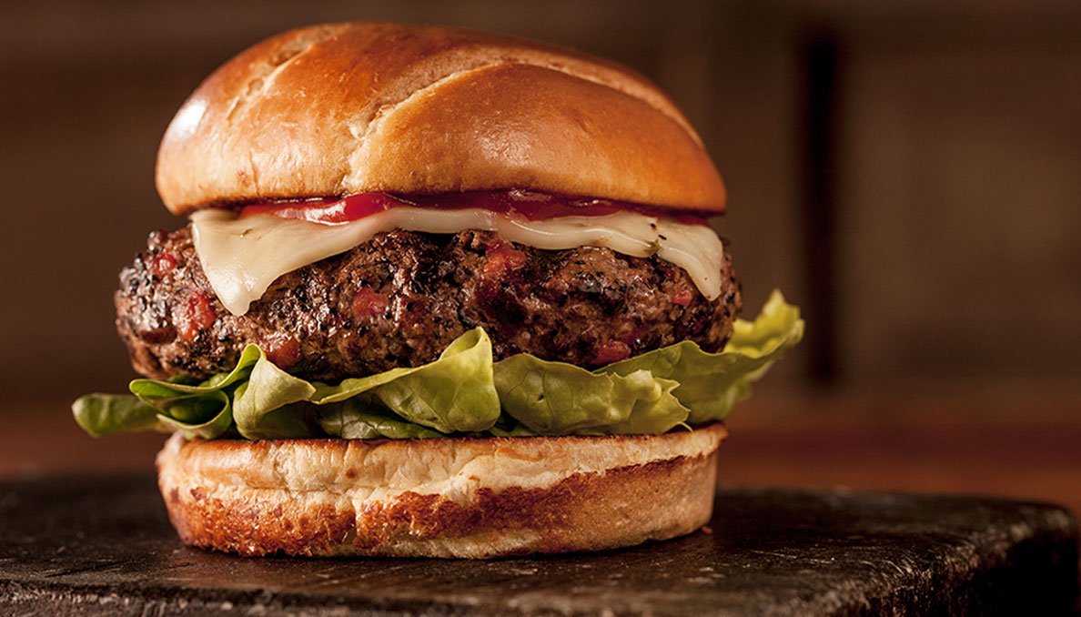 Image of Spicy Tomato Burger on bun with cheese and red gold ketchup