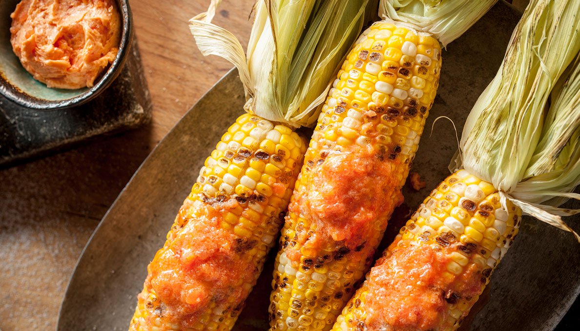 Image of Tomato buter meleted on grilled corn