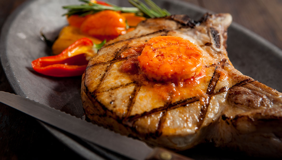 Tomato butter on grilled pork chop