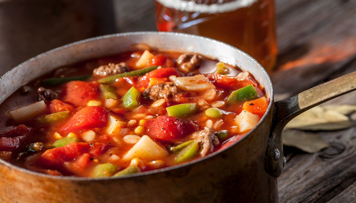 Image of vegetable soup in pot using canned diced tomatoes and tomato juice
